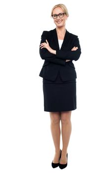 Full length shot of confident female manager posing with crossed arms