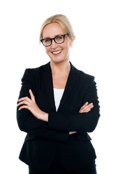 Confident female executive wearing eyeglasses, posing with arms crossed