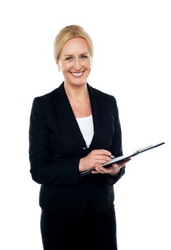 Smiling caucasian corporate woman writing on clipboard