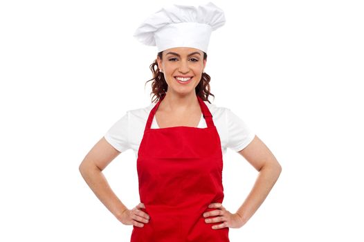 Cure female chef posing with hands on her waist. Calm and relaxed