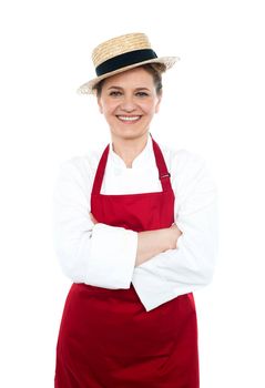 Lady cook in white red uniform wearing trendy hat and posing with crossed arms