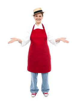 Cook posing with open palms welcoming you, full length portrait