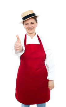 Lady chef in hat with thumbs up gesture in front of camera