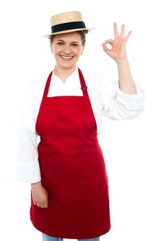 Beautiful trendy cook in hat gesturing excellent sign to camera