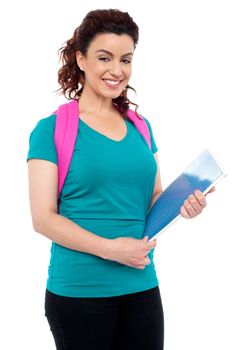 Charming college girl smiling and looking at you. All on white background
