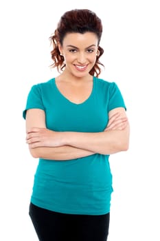 Sweet smiling young woman posing casually with her arms crossed isolated on isolated white background