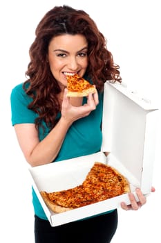 Young cheerful girl enjoying pizza alone. All on white background