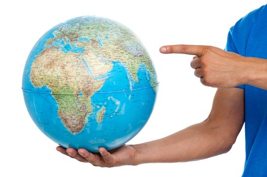A finger pointing at the globe. closeup shot over white background