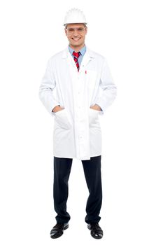 Full length portrait of young architect standing with hands in coat pocket