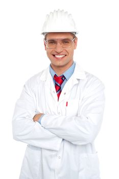 Male architect wearing safety glasses and hard hat. Dressed in white uniform  with arms folded