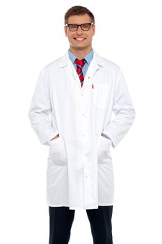 Stylish portrait of handsome male doctor posing with hands in pocket
