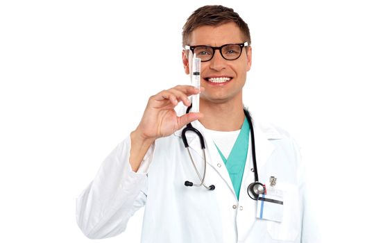Isolated smiling male doctor with an injection needle with white fluid.
