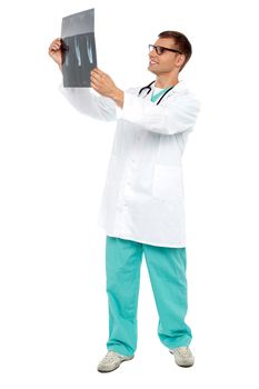 Handsome surgeon looking on patient,full length portrait