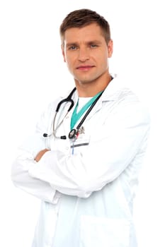 Handsome young doctor posing with crossed arms against white background