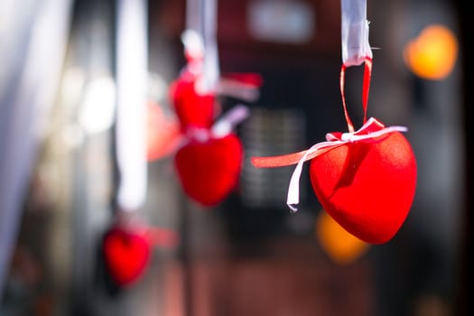 Red decorative heart hanging on the ribbon