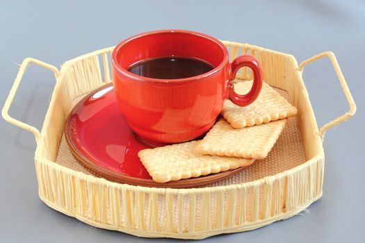 coffee and biscuits on a handmade trellis tray over gray background