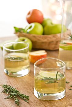 Apple juice with apple slices and rosemary