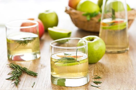 Apple juice with apple slices and rosemary