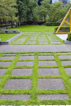 Grass Growing Between Concrete Pavers in Public Parks Landscaping
