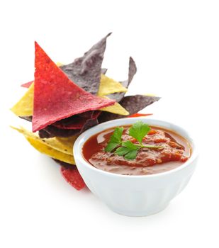 Bowl of salsa with colorful tortilla chips isolated on white background