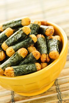 Bowl of Japanese rice and seaweed crackers Nori Maki