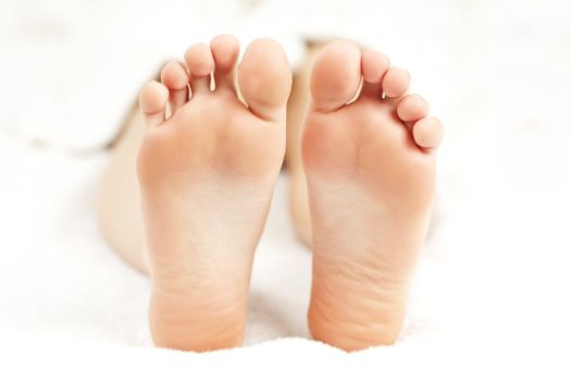 Soles of soft female bare feet in closeup