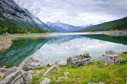 Mountains reflecting in Medicine Lake in Jasper National Park, Canada