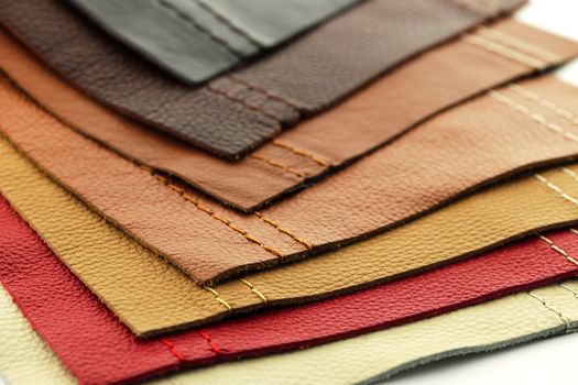 Natural leather upholstery samples with stitching in various colors