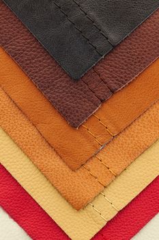 Natural leather upholstery samples with stitching in various colors