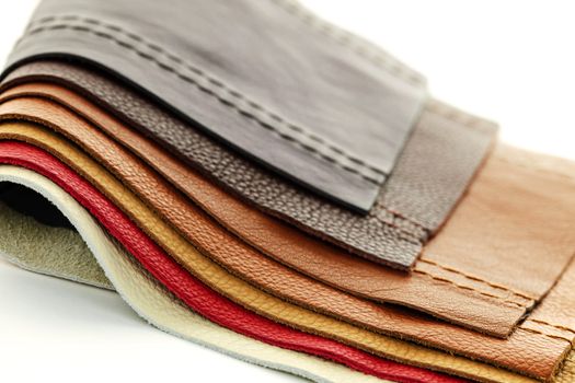 Natural leather upholstery samples with stitching in various colors