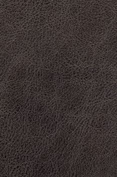 Dark brown natural leather background or texture close up