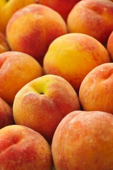 Ripe fresh peaches as background close up