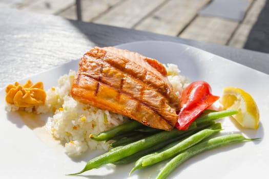 Grilled Salmon Filet Over Basmati Rice with String Beans and Bell Peppers