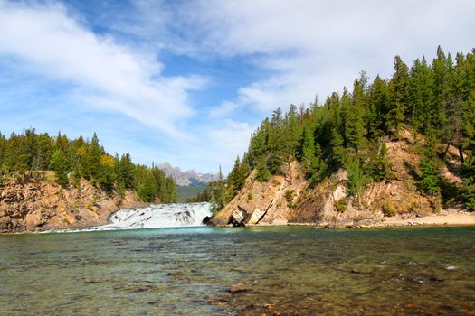 View of Bow Falls flowing through the woodlands of Canada near Banff, Alberta.