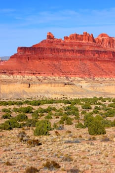 Bright red rock mountains near the Black Dragon Canyon in Utah.