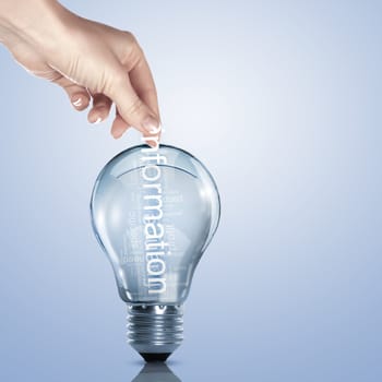 Human hand putting word Information inside a light bulb
