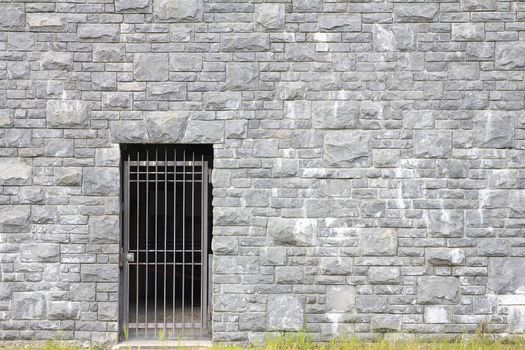 Metal Gate Entrance on Stone Rock Wall Background