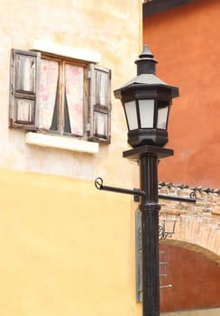 ancient lamppost with vintage window and wall background