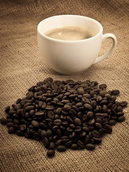 coffee beans with coffee cup on the cloth sack