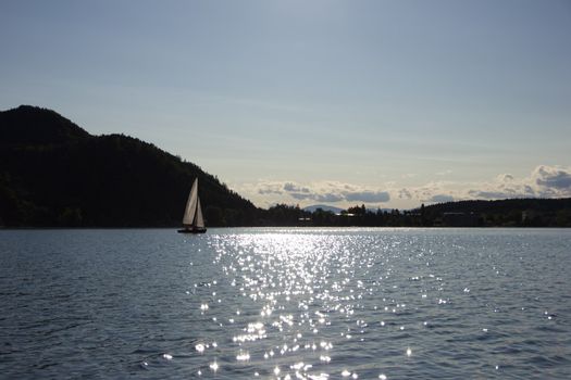 A sailboat gliding on the lake