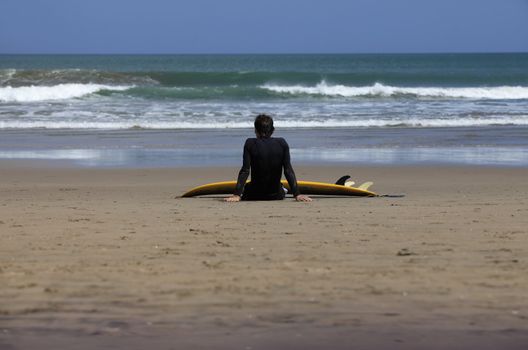 Surfer on a coastline expecting the big wave. Bali
