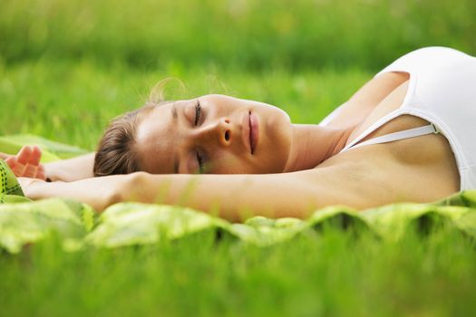 Beautiful woman sleeping on the grass 