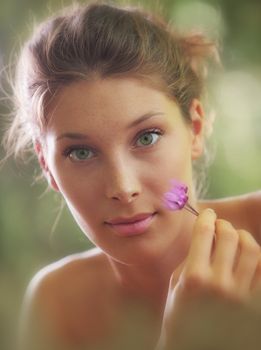 Portrait close up of young beautiful woman with flowers