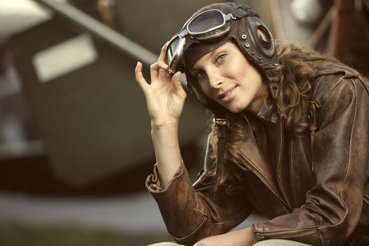 Portrait of young woman airplane pilot. Fashion model