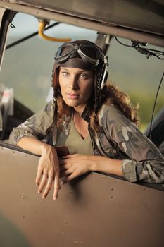 Portrait of young woman pilot in a military airplane