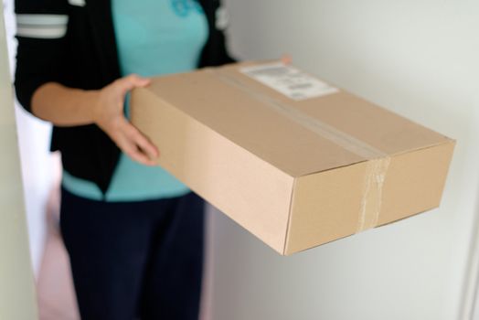 Woman picking up a parcel at her flat