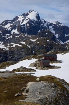 Hermannsdalstinden, highest peak of western Lofoten islands in Norway with mountain cabin in the foreground