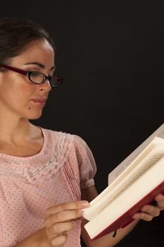 An intellectual looking woman holding a book