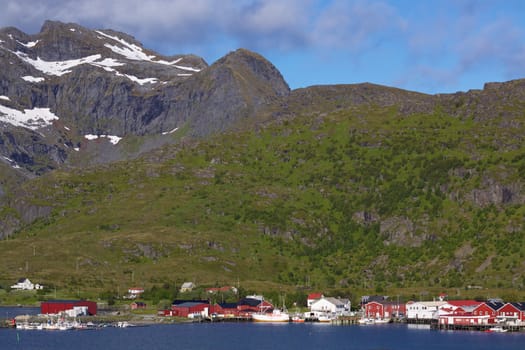 Traditional norwegian fishing village with red buildings on Lofoten islands in Norway