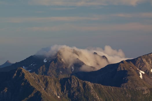 Mountain peaks in clouds on Lofoten islands in Norway